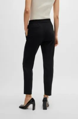 Pantalones slim fit de punto técnico elástico
